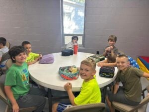 Group Of Boys Eating Lunch Together